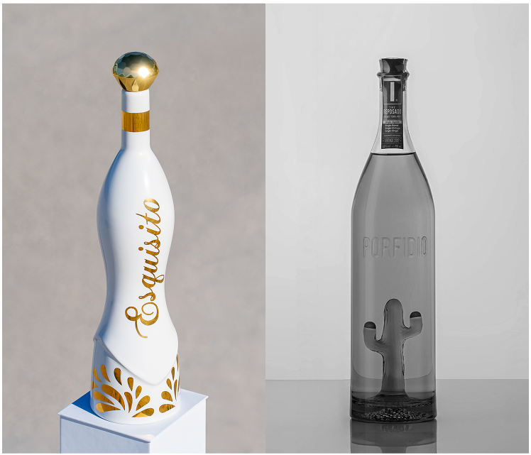 Two unique bottles(one is Esquisto Tequila), one white with gold text and the other black with a cactus design, on a neutral background.